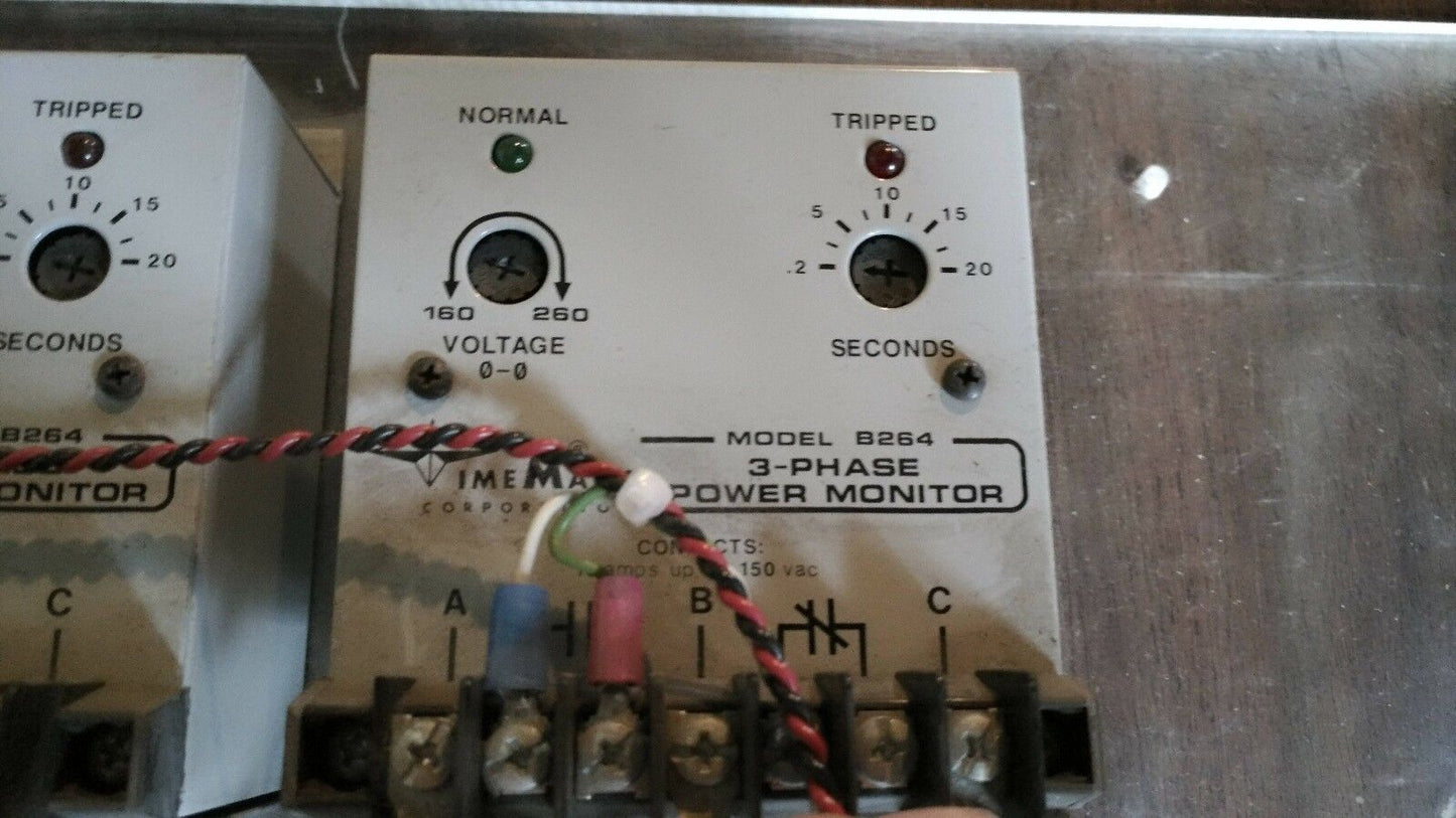 Two TimeMark B264 3-Phase Power Monitors mounted on plastic