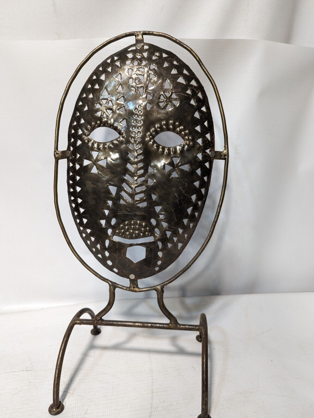 Metal mask on stand, 20.5 inches tall by 11 inches wide