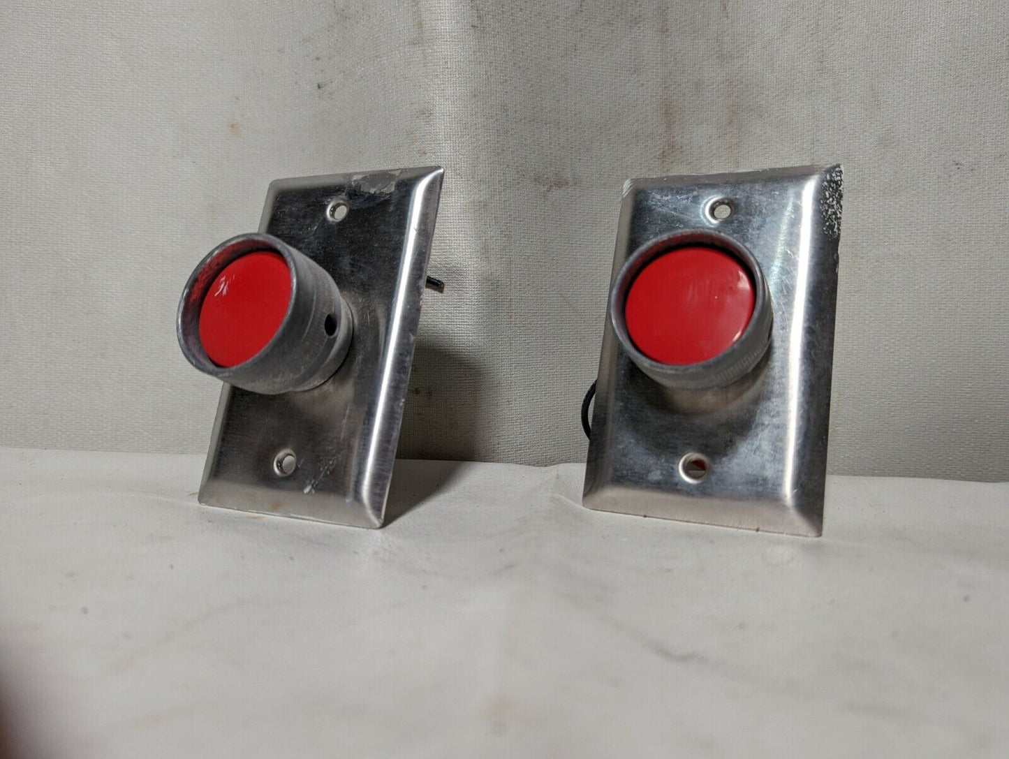 Lot of 2 GE CR104P red pushbutton switches mounted on stainless steel cover plat