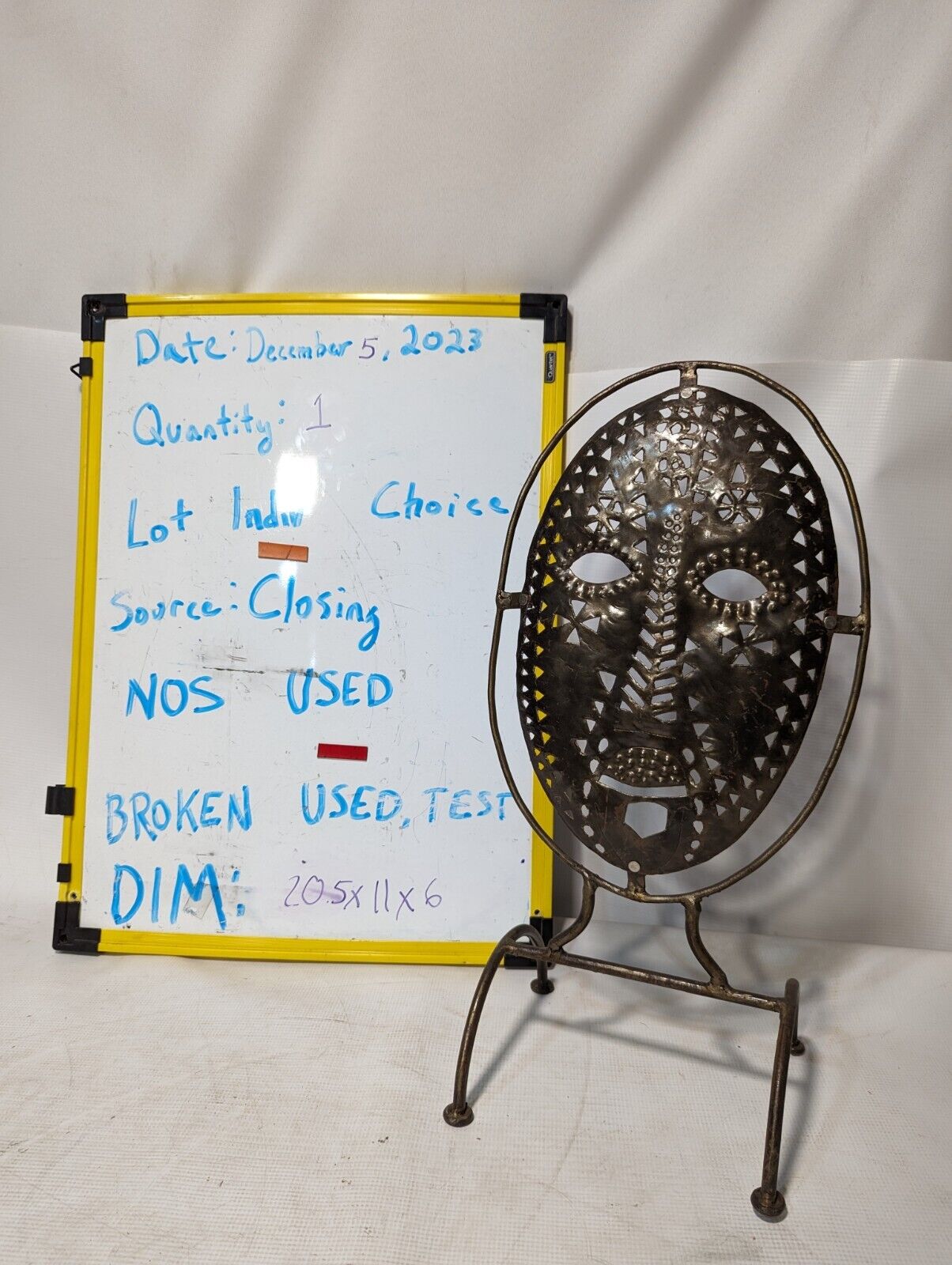 Metal mask on stand, 20.5 inches tall by 11 inches wide