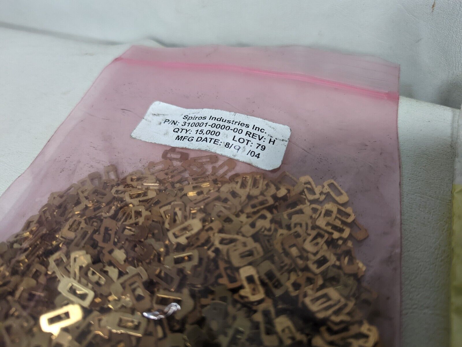 Spiros Industries 310001-0000-00 brass clips (two bags) and another unmarked bag